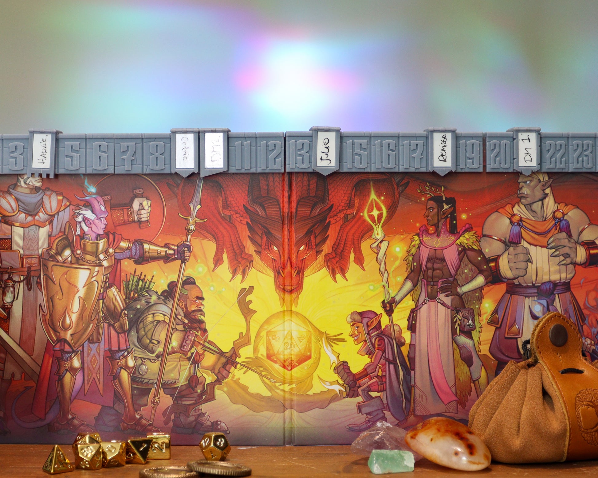 The world's best initiative tracker to speed up your dnd combat, mounted on a 5e 2024 dungeon master's screen. Golden dice are placed in front of the screen, as well as a leather dice bag, and some gemstones.