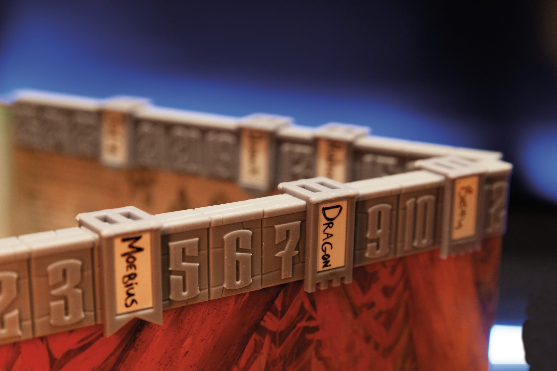 The Initiative Tracker, mounted on a Dungeon Master's screen. There are banners on the tracker for a player character called Moebius, as well as a dragon.